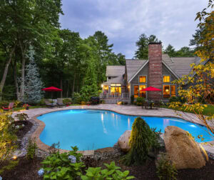 Landscape design. Gunite pool with stone paver deck. Landscaped flowerbeds. Dex by Terra pool renovation in Carlisle, MA.