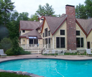 Pool with home in background showing the pool area before Dex by Terra conducted a pool renovation project.