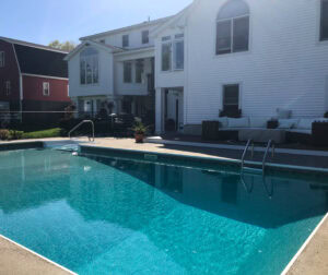 A view of our Auburn, MA client's inground pool before Dex by Terra's pool renovation took place.
