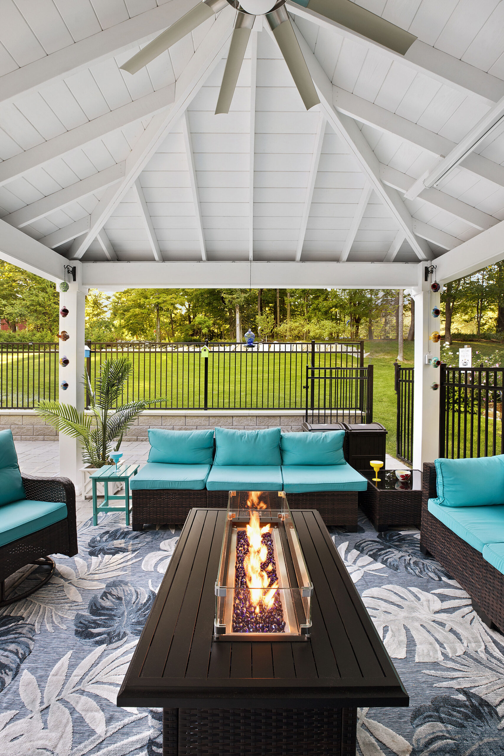 The pool house pavilion with ceiling fan and fire pit. Dex by Terra landscape and hardscape project in Westminster, MA.