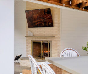 TV and wood burning fireplace under the patio pavilion. Outdoor living designed and built by Dex by Terra in North Attleboro, MA.