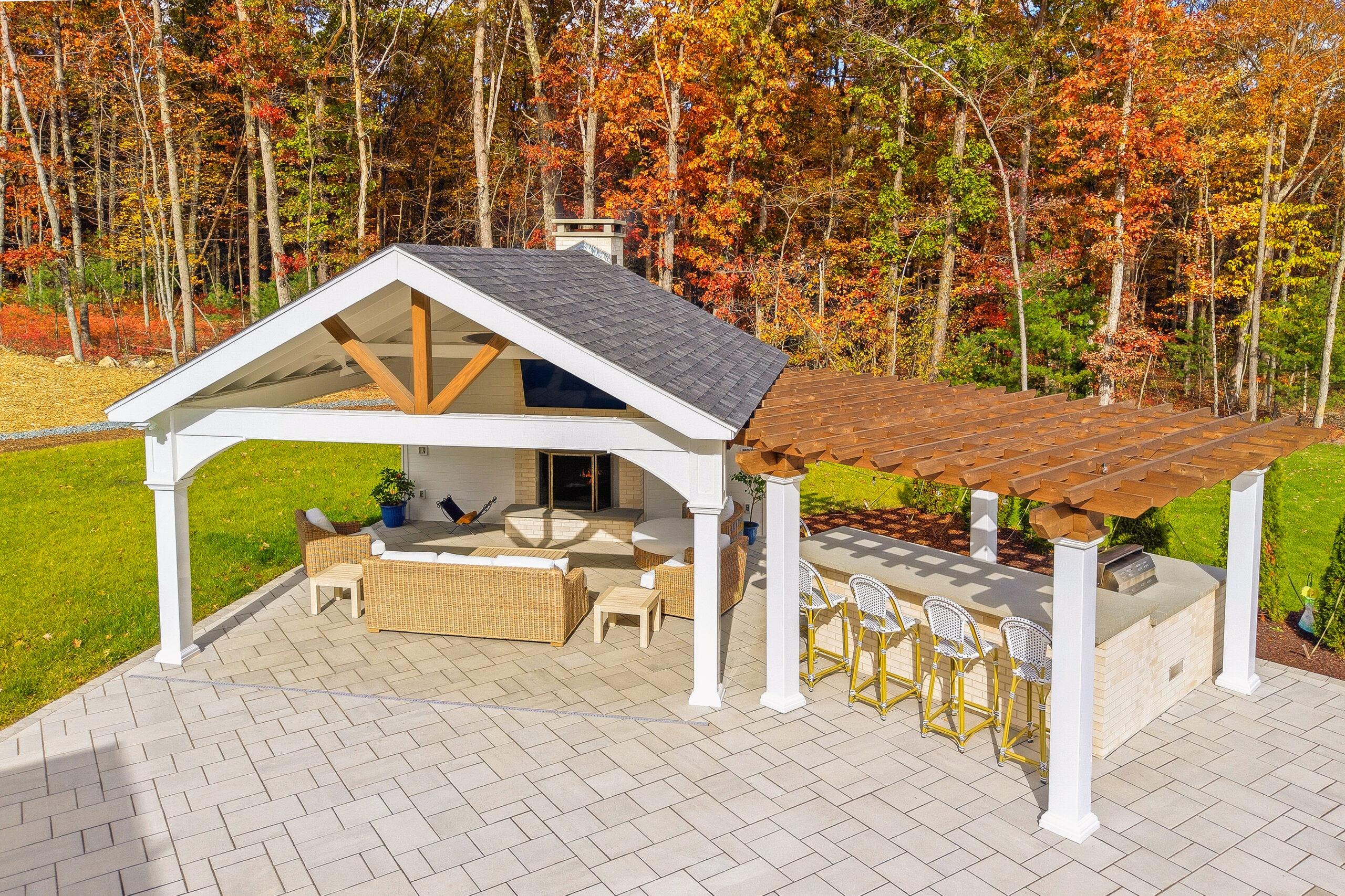 Backyard patio, pavilion, fireplace, pergola, and outdoor kitchen design and build by Dex by Terra in North Attleboro, Massachusetts.