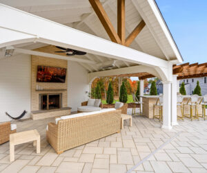 Patio pavilion with privacy wall and fireplace designed and built by Dex by Terra in North Attleborough, MA.