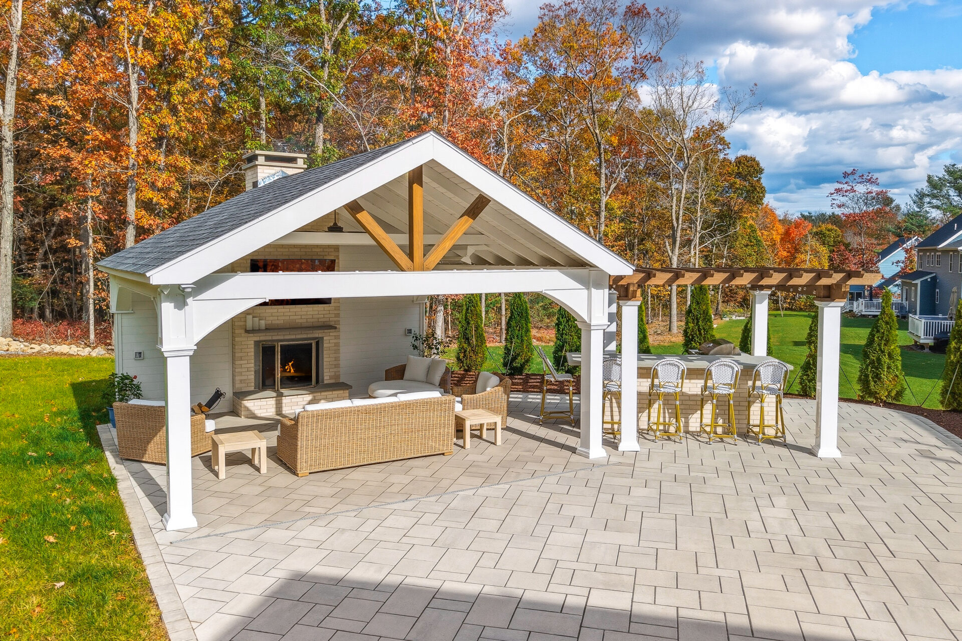 Backyard patio, pavilion, fireplace, pergola, and outdoor kitchen design and build by Dex by Terra in North Attleboro, Massachusetts.