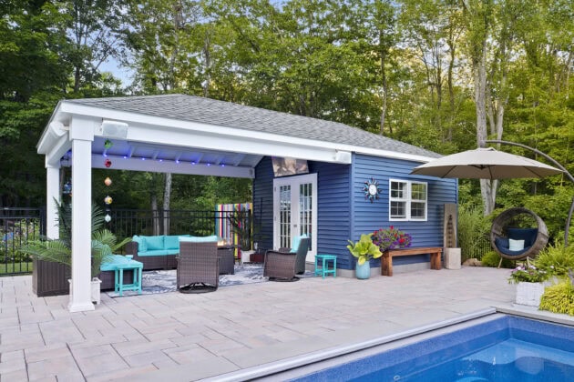 The pool house and pavilion with fire pit and seating. Dex by Terra landscape and hardscape project in Westminster, MA.