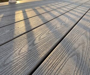 A closeup of grey composite decking showing texture.