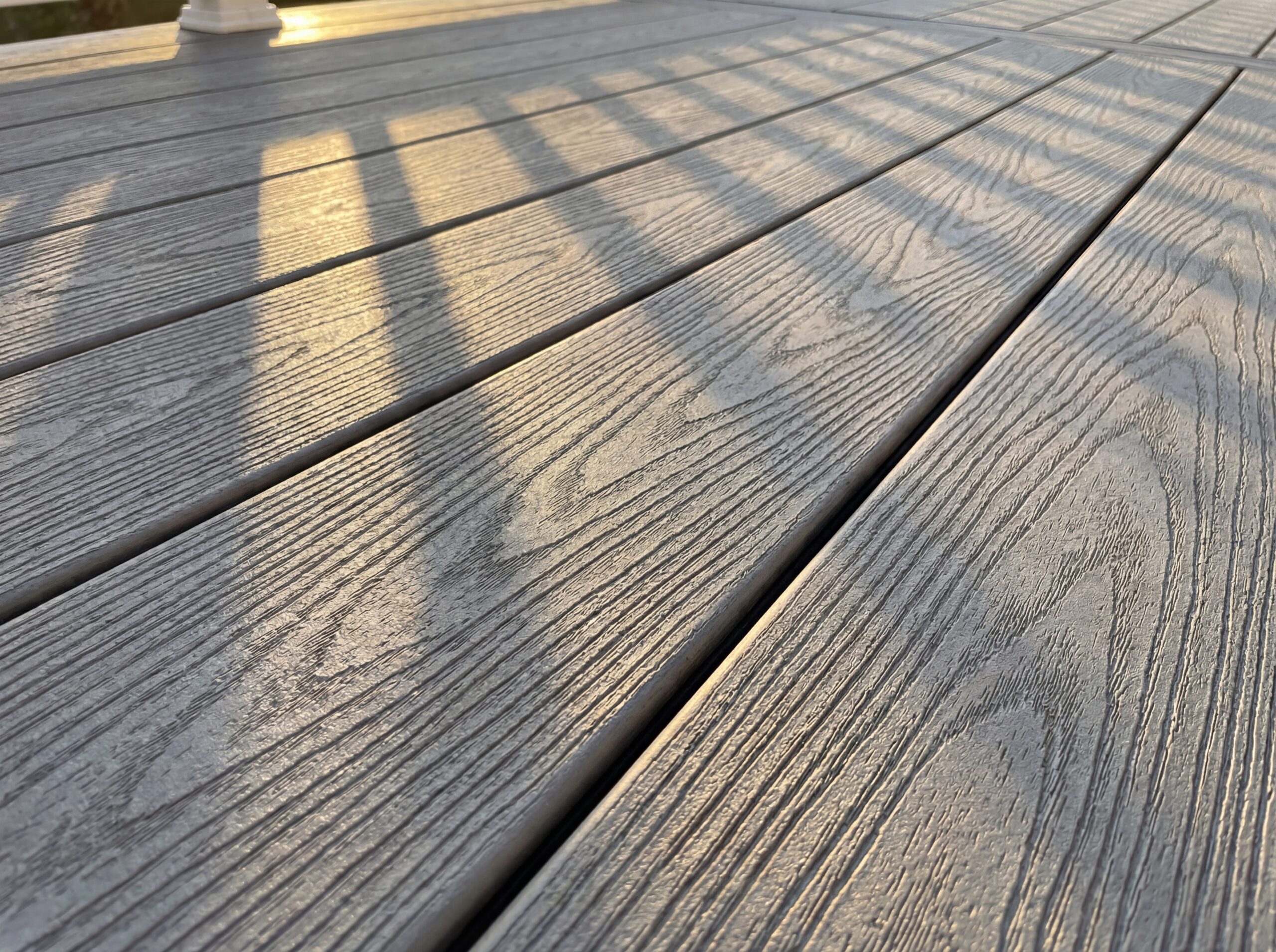 A closeup of grey composite decking showing texture.