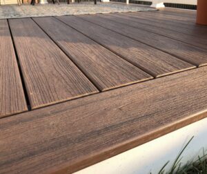 A closeup of brown composite decking showing texture.
