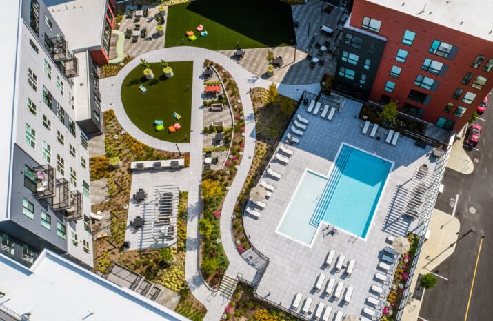Podium-level Courtyard with pool, and patios at The Revington in Worcester, MA. Hardscape & Landscape by Dex by Terra.