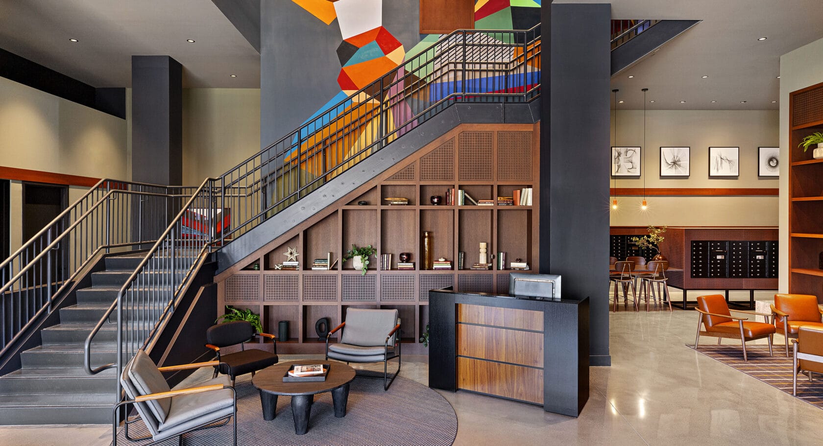 The lobby and main staircase of 75 Canal Apartments in Manchester NH with polished concrete floor.