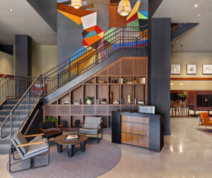 The lobby and main staircase of 75 Canal Apartments in Manchester NH with polished concrete floor.