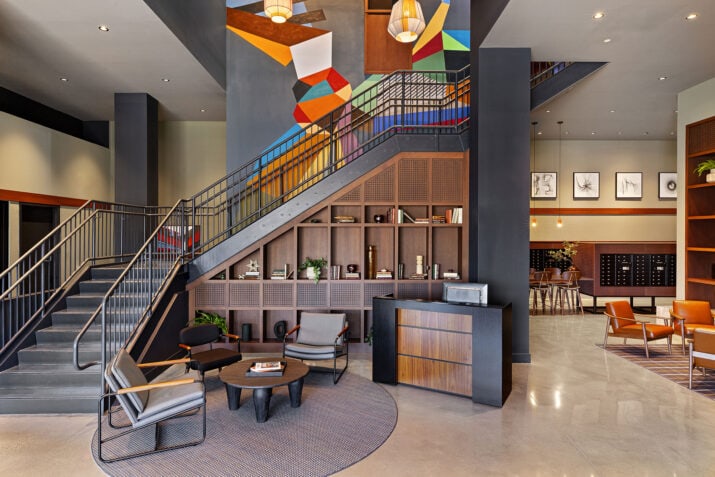 The lobby and main staircase of 75 Canal Apartments in Manchester NH with polished concrete floor.