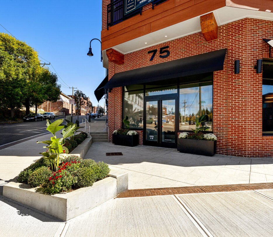 The brick main entrance and front sidewalk of 75 Canal Street Apartments in Manchester New Hampshire.