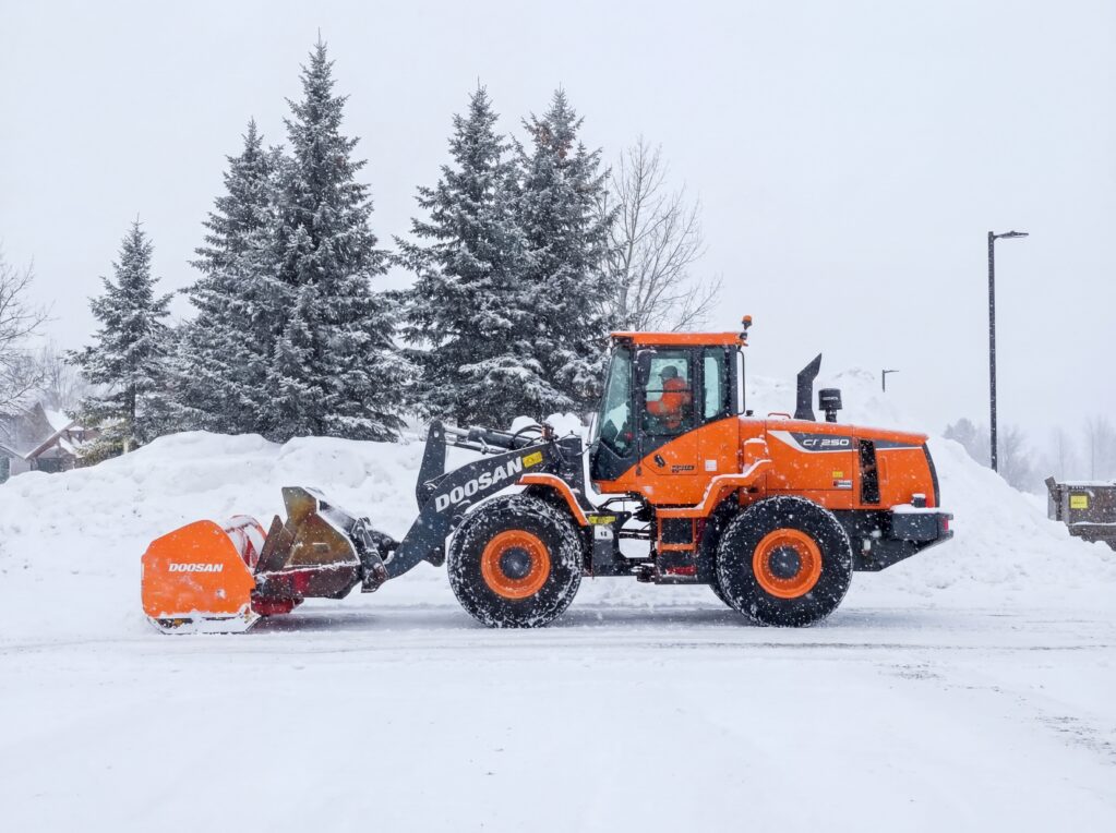 A Dex By Terra Commercial Snow Removal & Management Wheel Loader being used as a plow.