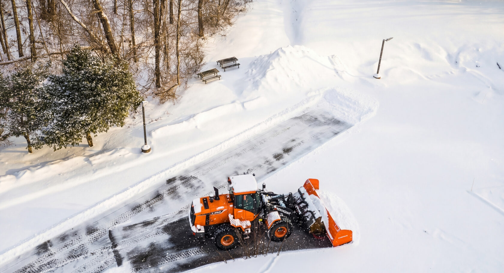 A Dex By Terra Commercial Snow Removal & Management Wheel Loader being used as a plow.