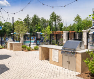 A grill station at The Penstone Apartments in Walpole, MA. Hardscaping and landscaping by Dex by Terra of Hudson, MA.