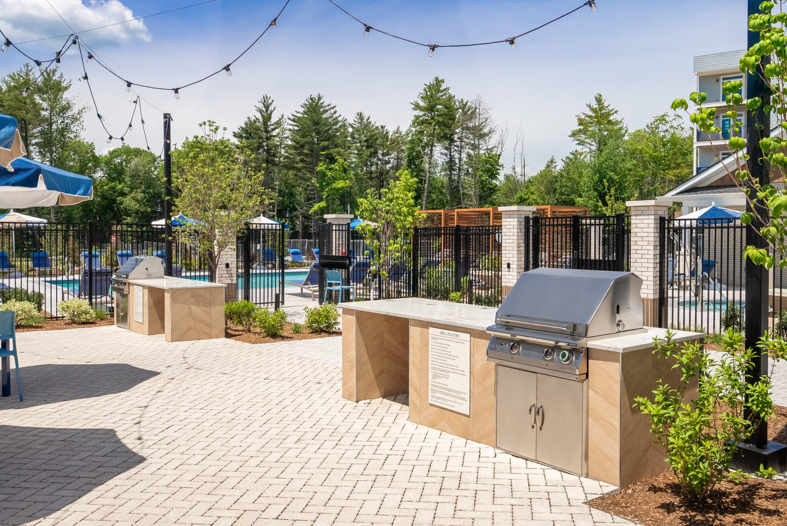 A grill station at The Penstone Apartments in Walpole, MA. Hardscaping and landscaping by Dex by Terra of Hudson, MA.