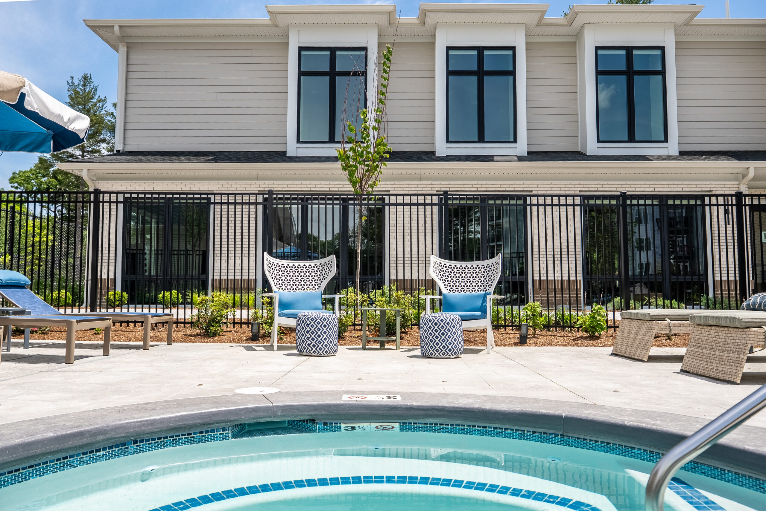 The spa area with seating and landscaped plant bed at The Penstone Apartments in Walpole, MA. Hardscaping and landscaping by Dex by Terra of Hudson, MA.